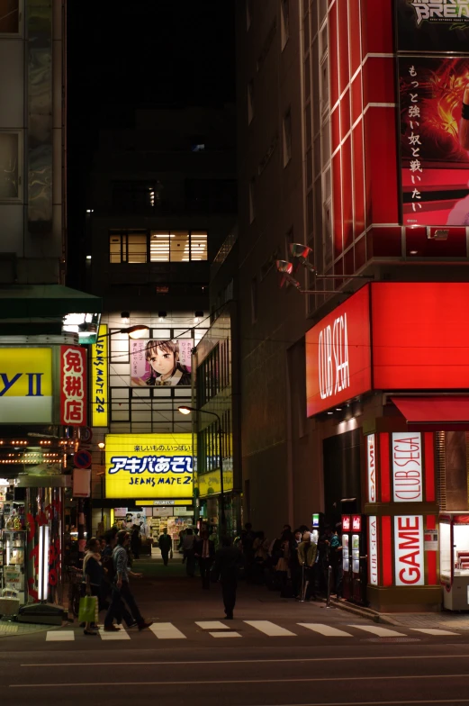 a very busy city at night time with lights and billboards