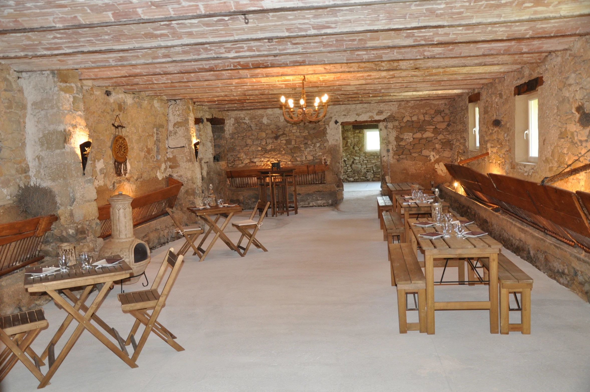 an empty room with some tables and chairs