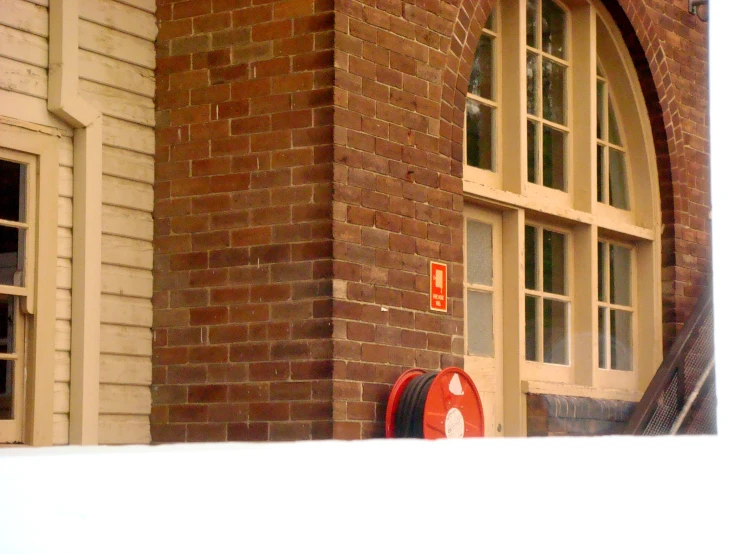 the corner of a brick building with an arched window