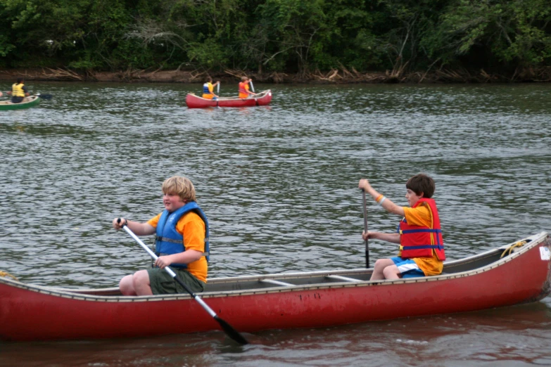 a couple of people are paddling a canoe