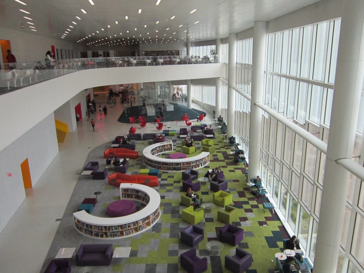 a large white building with chairs and a lot of windows