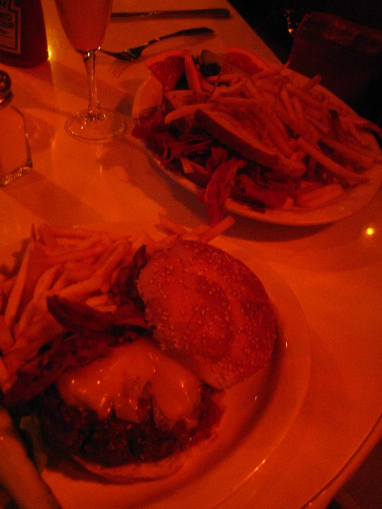 some plates of food that include sandwiches and french fries