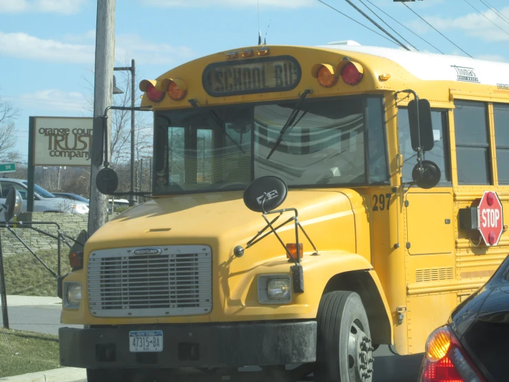 a yellow school bus is stopped at a stop sign