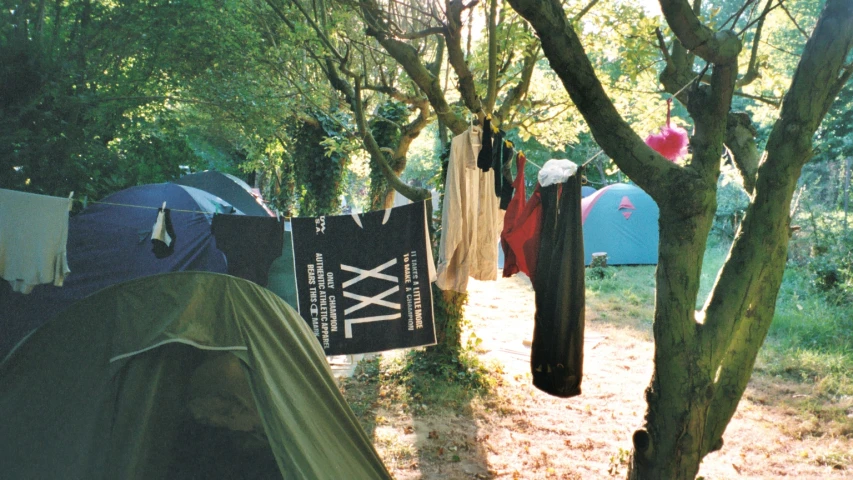 tents in the woods are covered with tarps