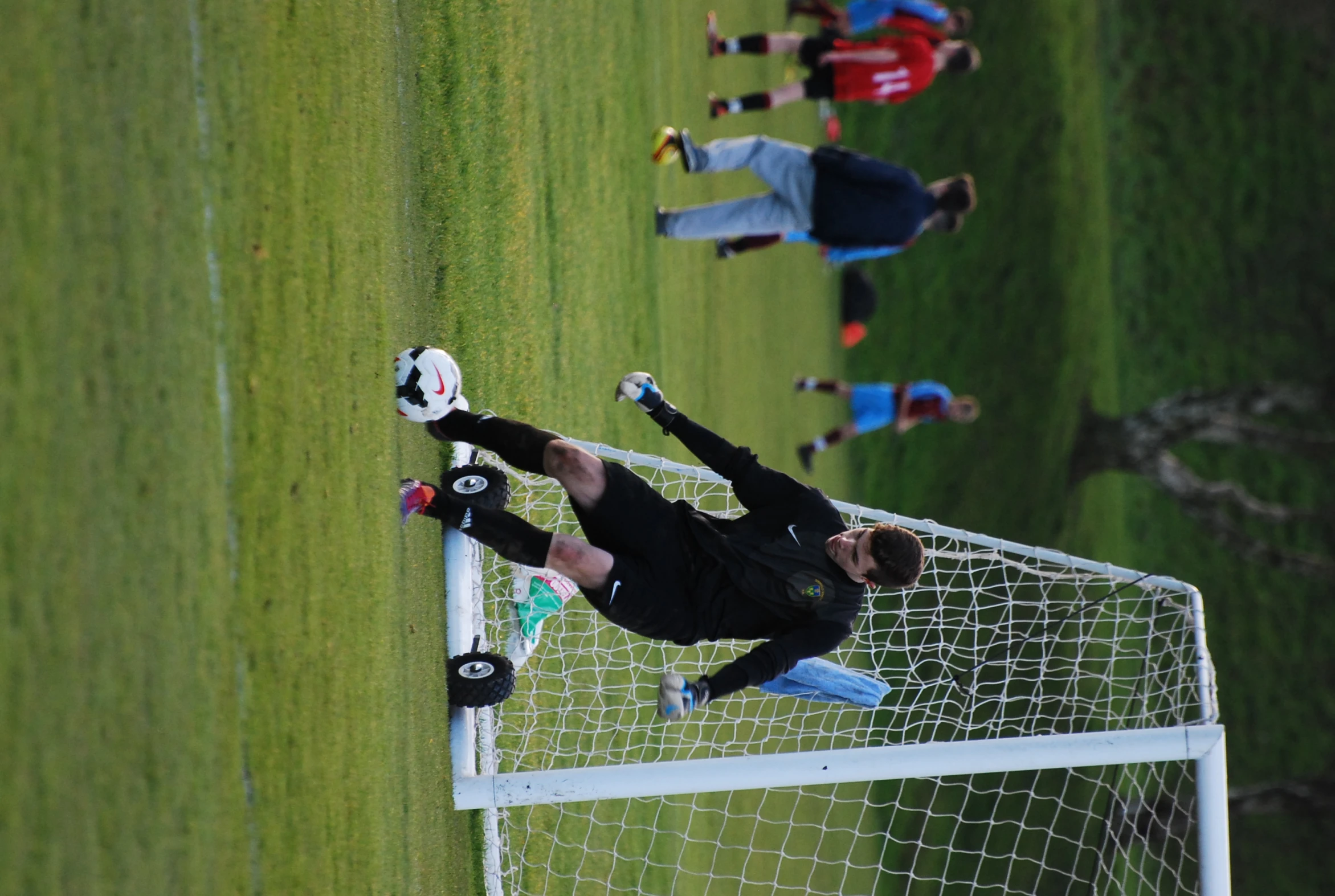 two boys are playing soccer together on the field