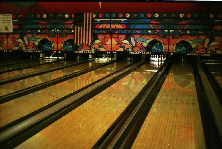 a bowling alley with painted lines and a number of bowling pins