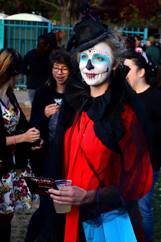 man with clown makeup and makeup in costume at event