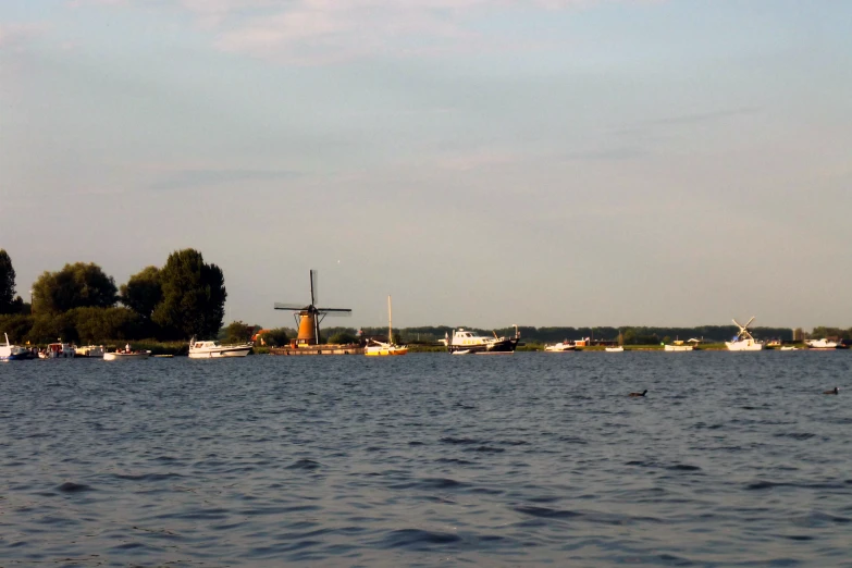 boats out on the water with windmills in the distance