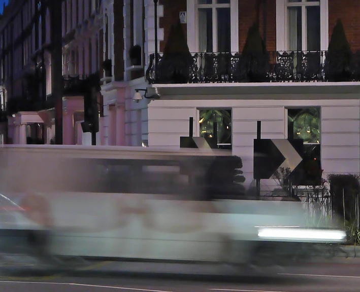 a train passes by a large building in the city