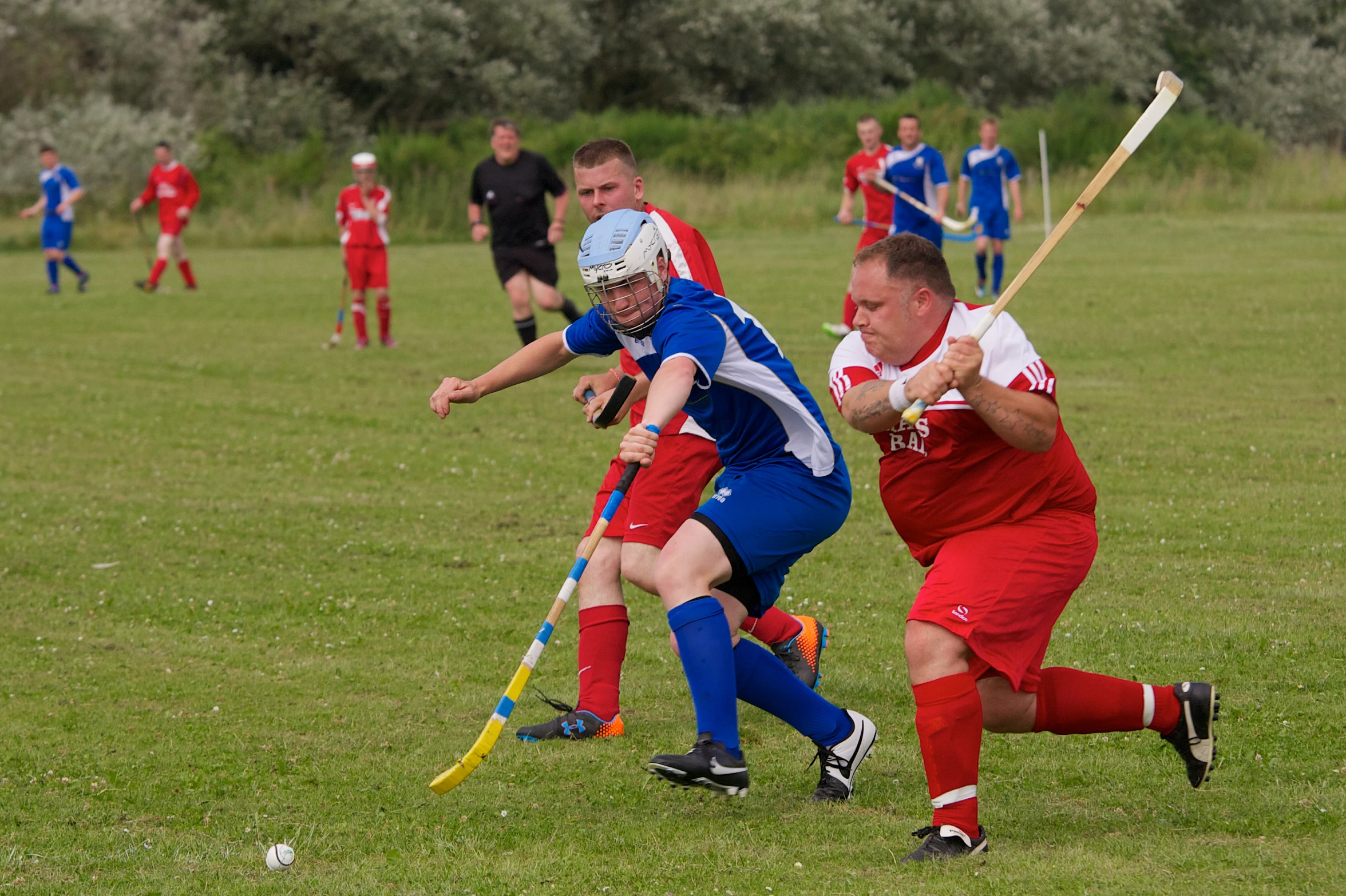 there is a group of boys playing a game of field hockey