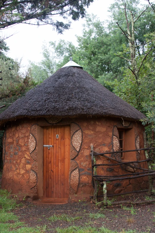 a mud house with an entrance and roof