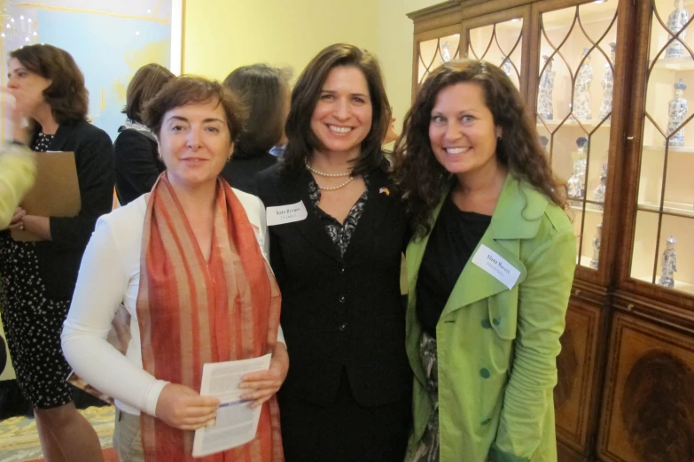 three women are all smiling at the camera