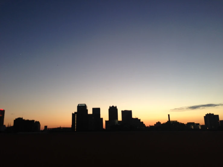 a skyline and a building in the distance at dusk