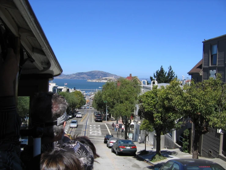 cars line the street in front of a house