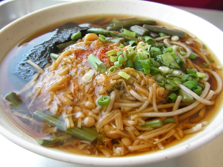 some noodles and vegetables in a white bowl