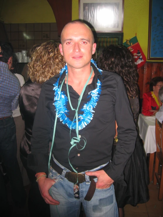 man with bright blue leis at party