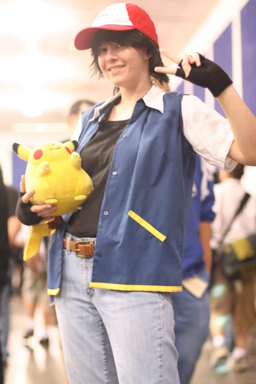 there is a woman in a pokemon costume holding a stuffed toy