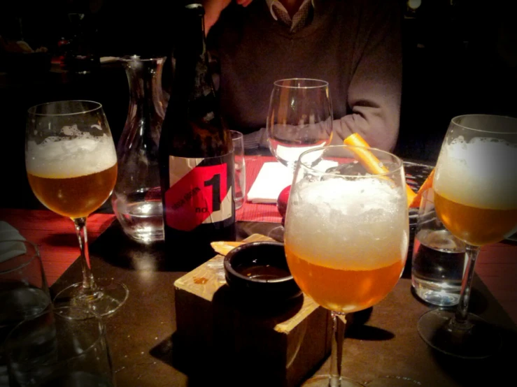 three glasses of beer sit on a table