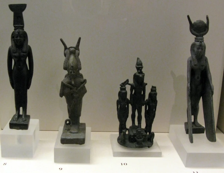 an assortment of ancient egypt figurines sit on display