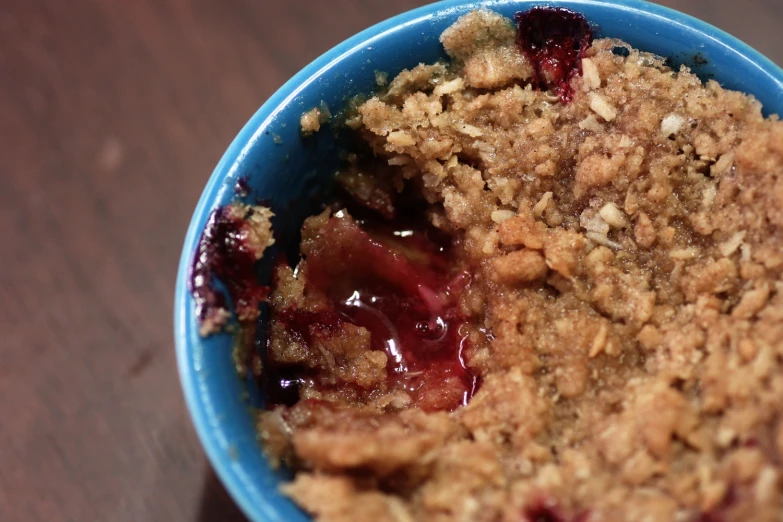 a dish of fresh fruit crumbles with jam