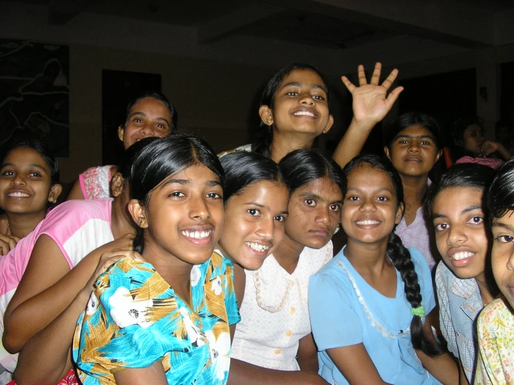 a large group of girls posing for a po