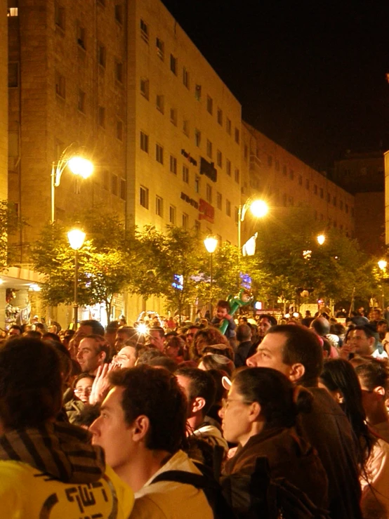 many people sitting together in a crowd