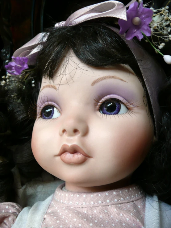 a doll has her eyes open and is wearing a flower crown