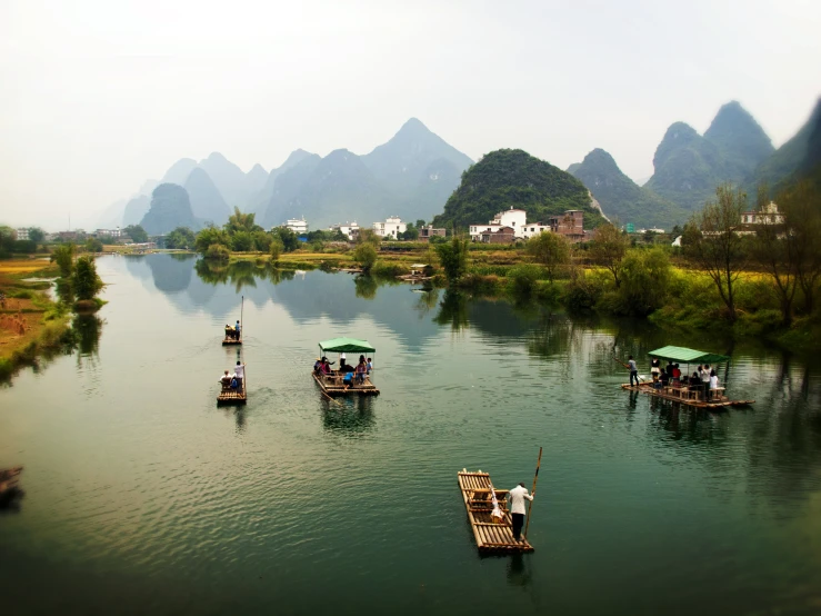 the boats on the river have umbrellas on them