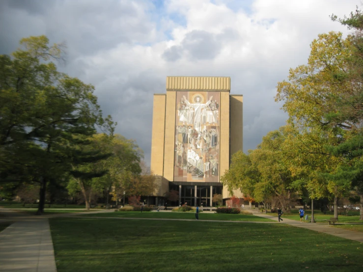 a very tall building with a mural on the side