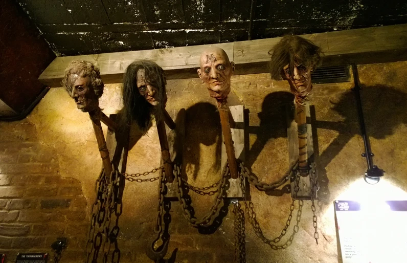 five fake heads of zombies and chains around them