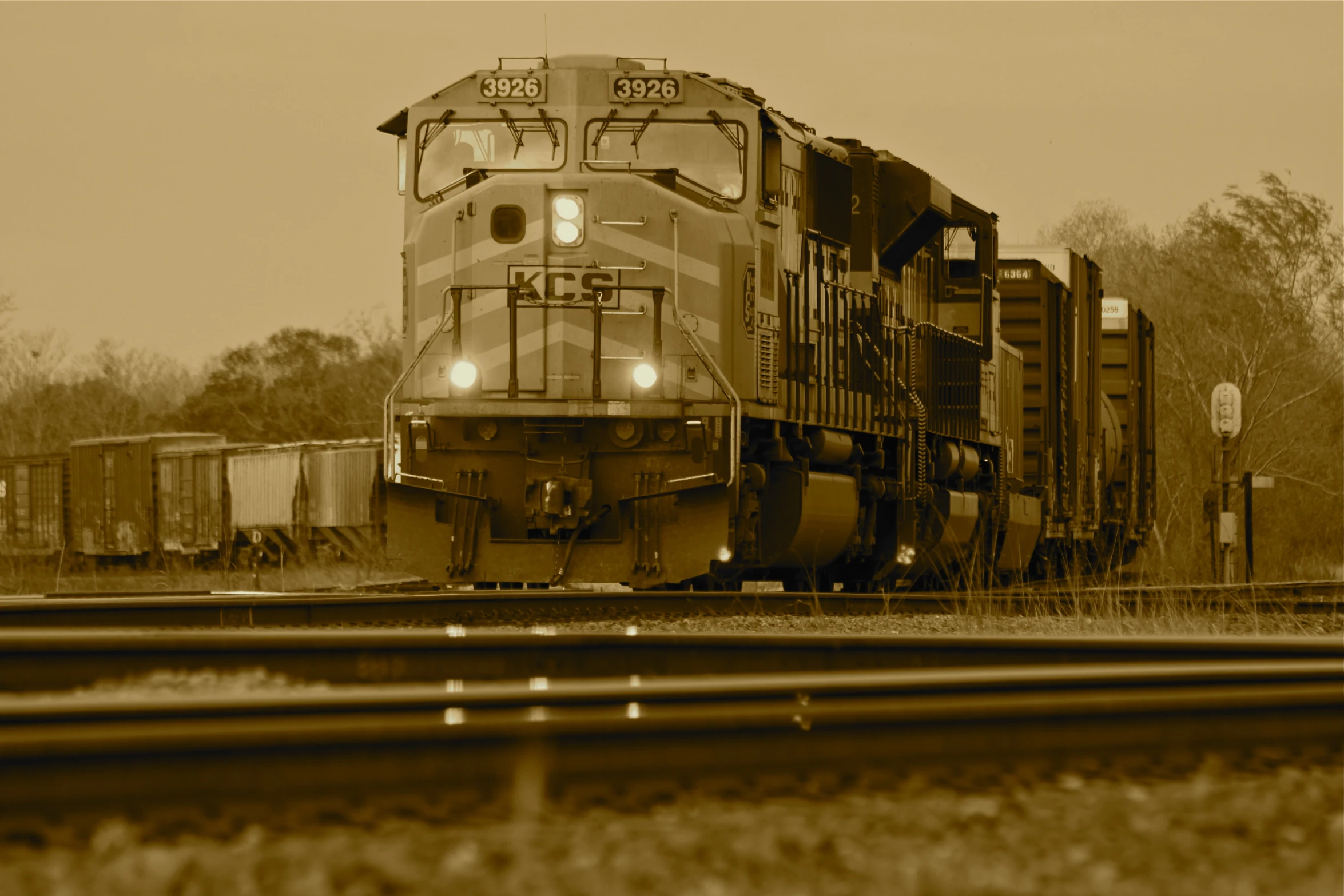 the back end of a train moving along a railroad track