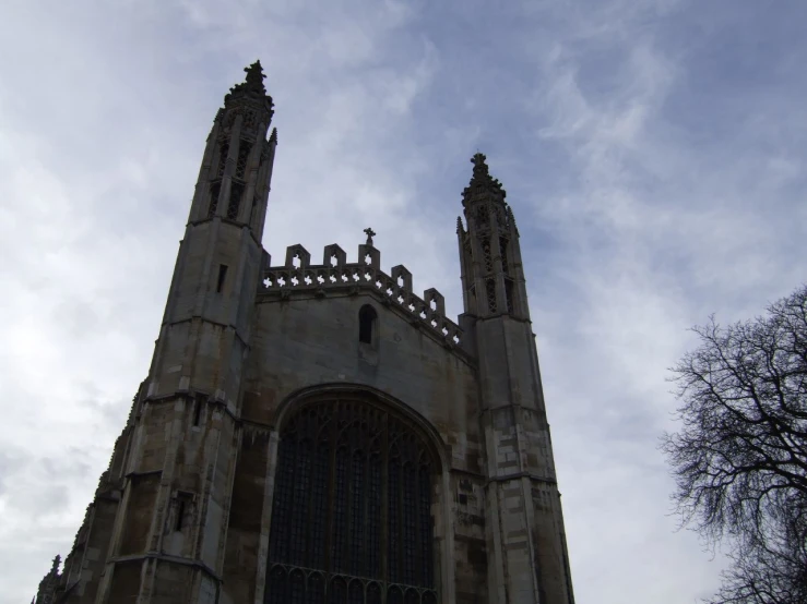 a large building has two towers with statues on them