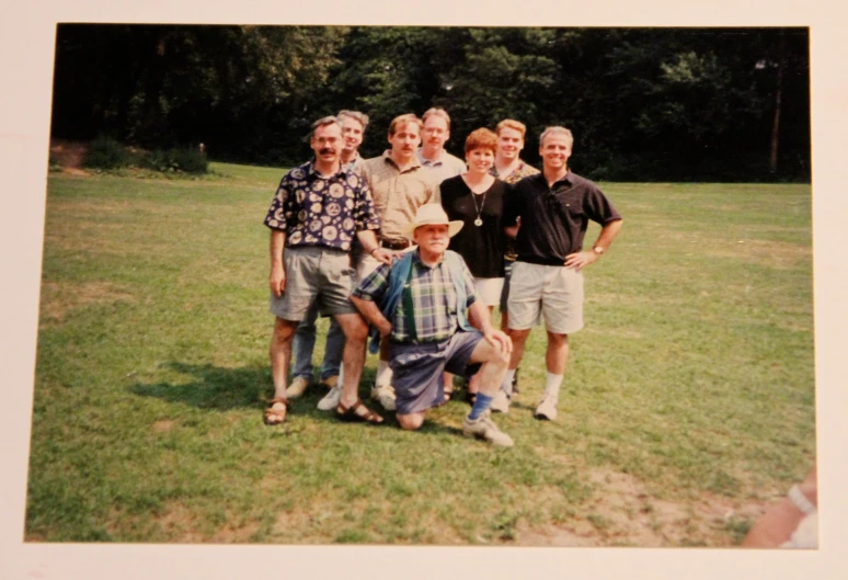 an older po of some men on a grass field