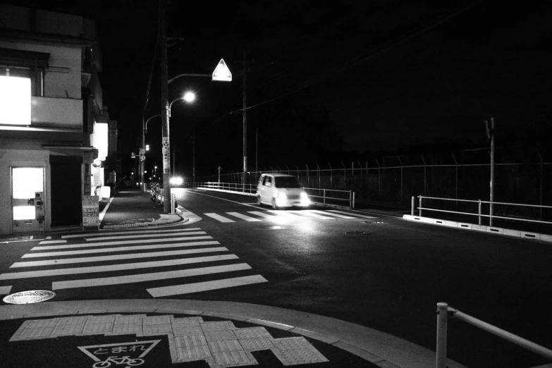 a black and white po of an empty road at night