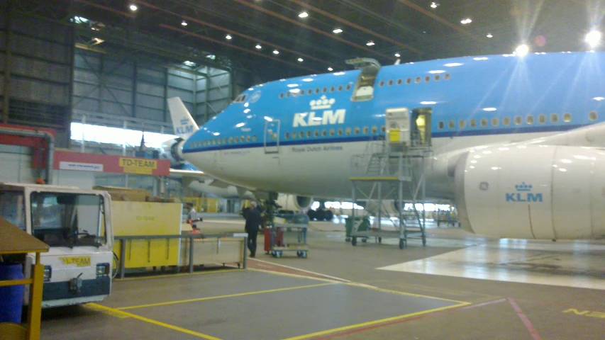 a large jetliner sitting inside of a hangar on top of tarmac