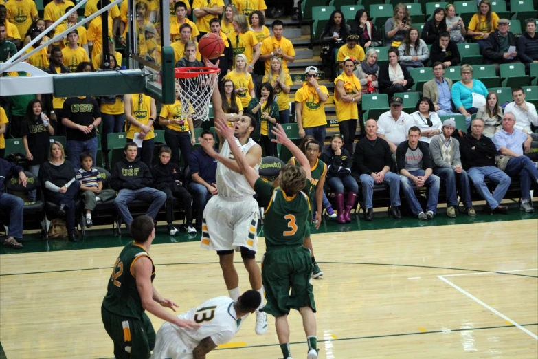 a group of people playing a game of basketball