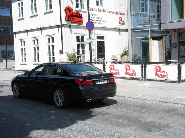 a black car that is sitting in the street