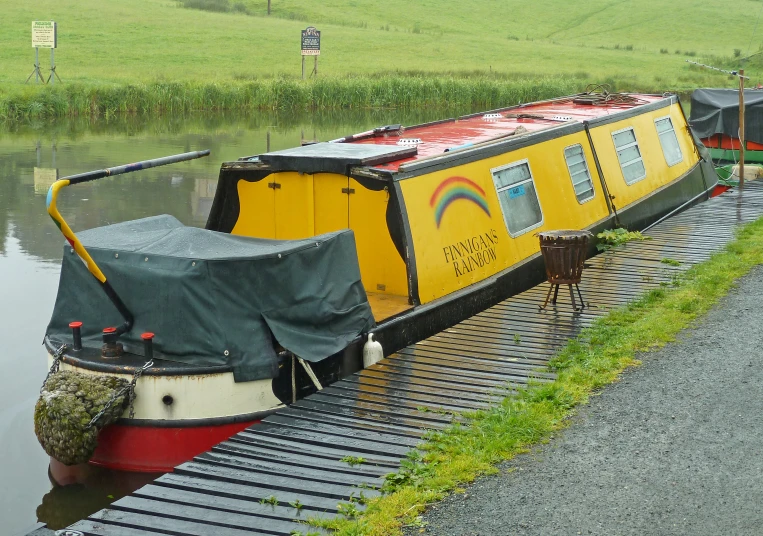 a houseboat that is parked by the water