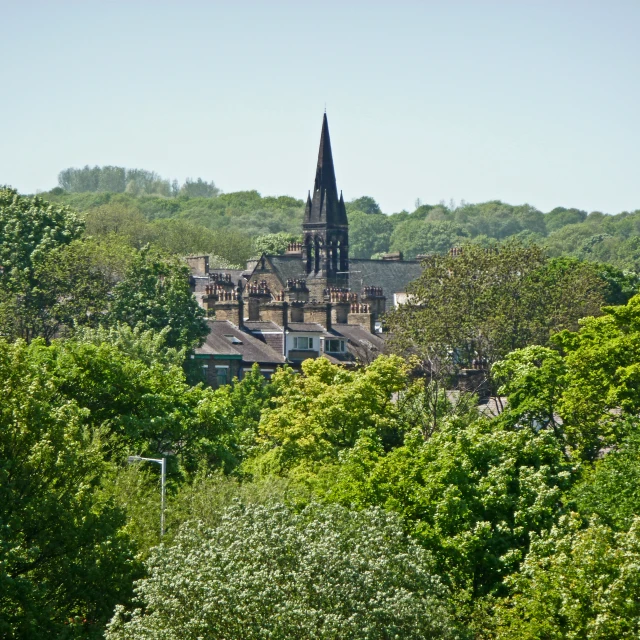 the church steeple on top of the building has a spire that stands tall