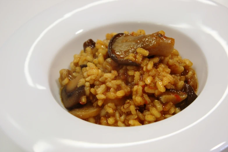 a plate of food that includes mushrooms, and rice