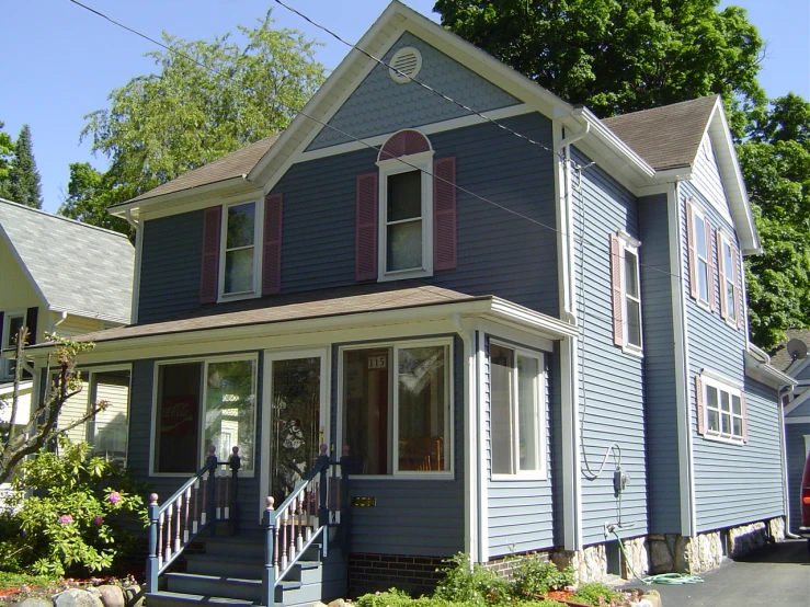 an old style blue house with red shutters