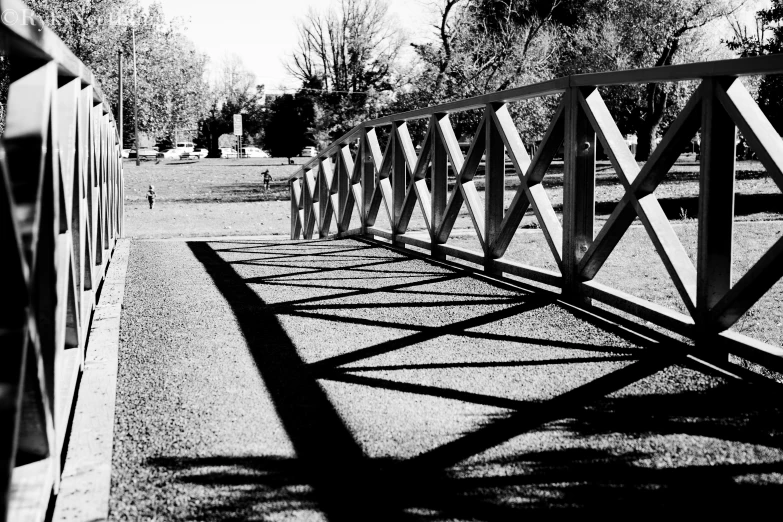 a long white bridge with a fence and benches