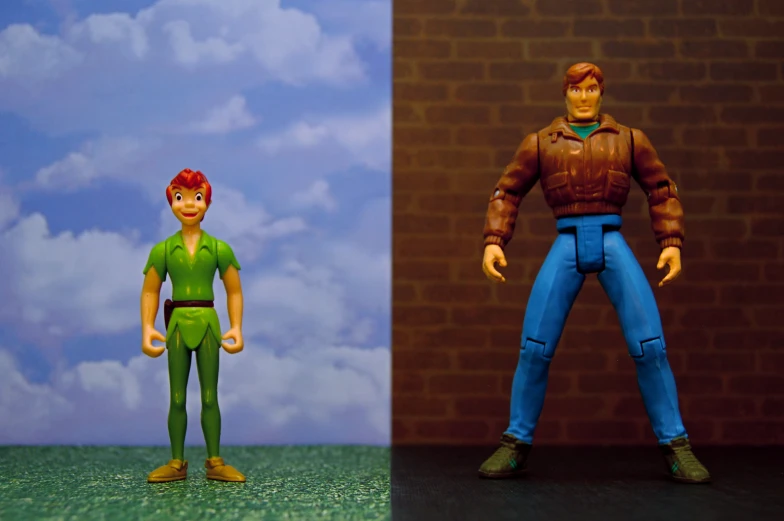 a pair of action figures depicting two men with heads to their backs