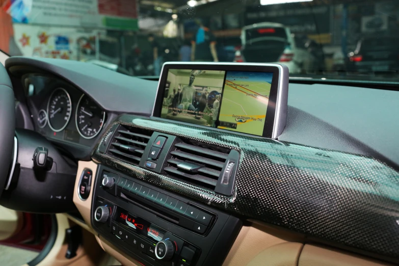 the dashboard of an automobile with a display showing images of people walking