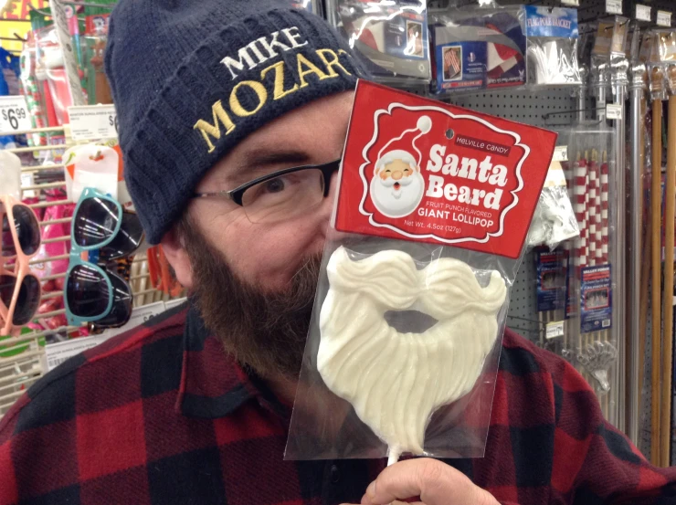 a man holding a fake beard in his hand