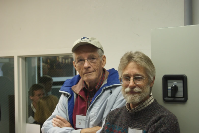 two older men standing next to each other