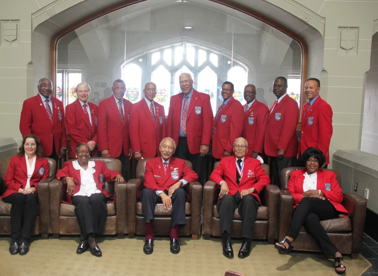 the men are all wearing red suits and ties