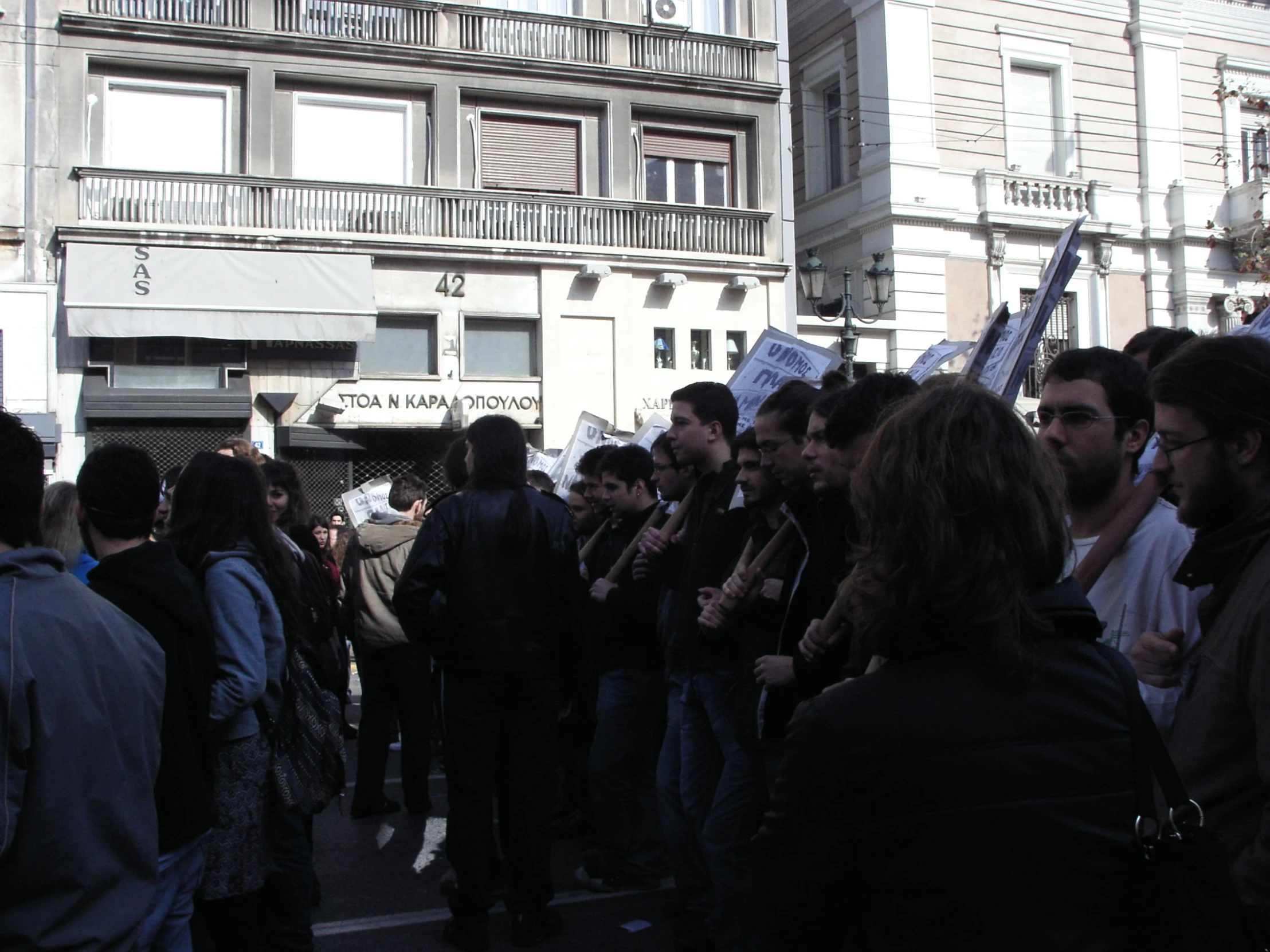 a bunch of people are gathered in a city street