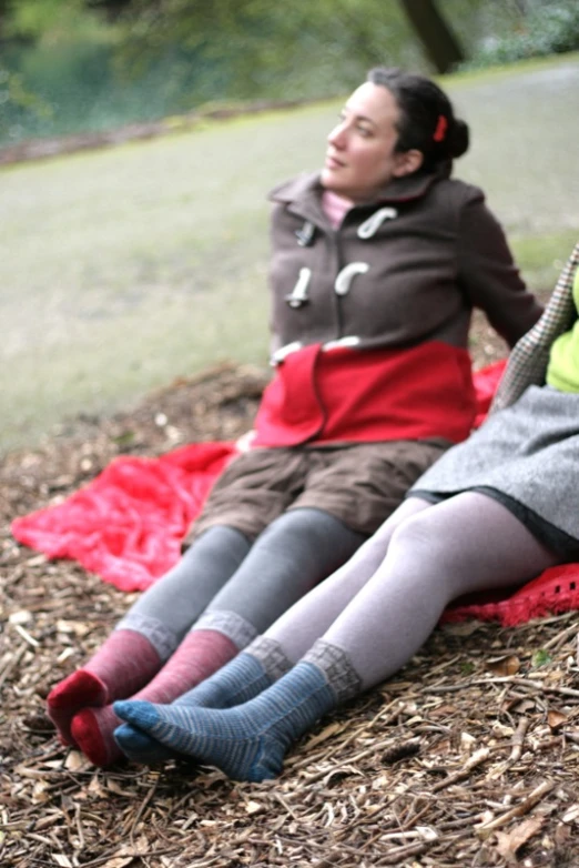 two women are resting on the ground in their matching socks