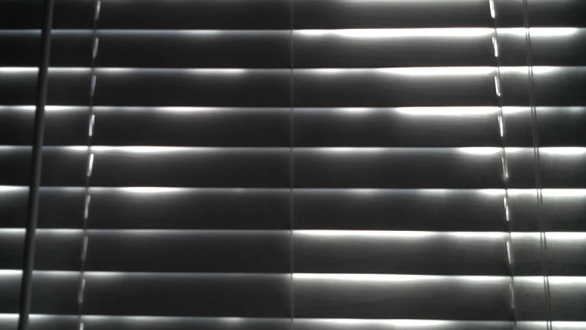 the blinds are dark and shiny in some light